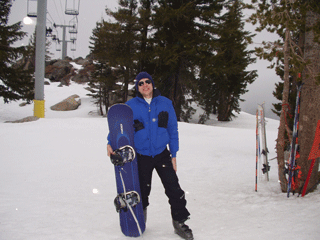 Skier Dale posing with a snowboard at Sierra at Tahoe 2/1/03.